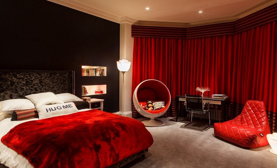 The long, red curtains give the room a theatrical look
